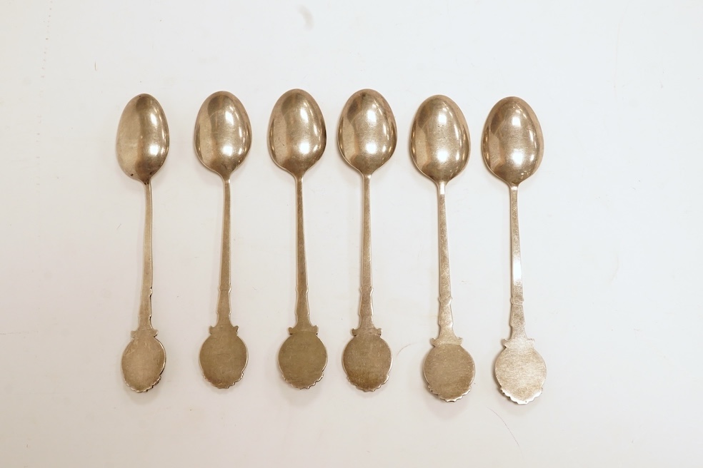 A matched set of six mainly George V silver/white metal and enamel teaspoons, with terminals decorated with dog's heads, 13.6cm. Condition - fair